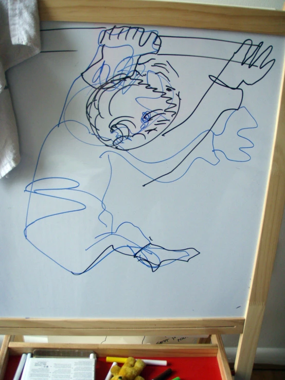 a white board with drawings on it is in a wooden frame
