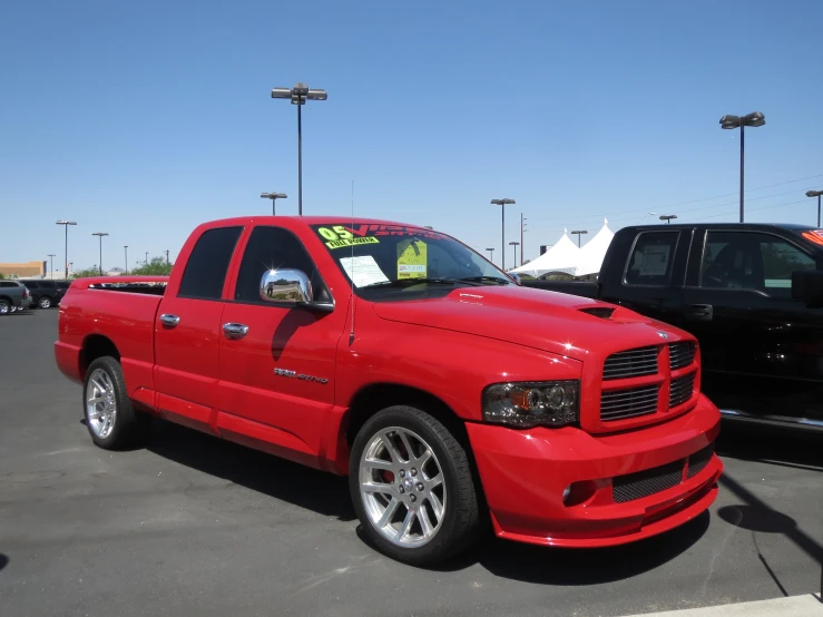 a red truck is sitting in the parking lot