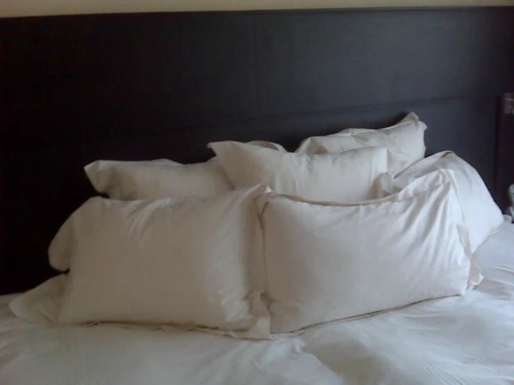 a very big pretty bed with many pillows