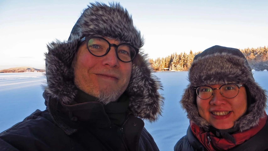 the man and woman are posing for the picture in the snow