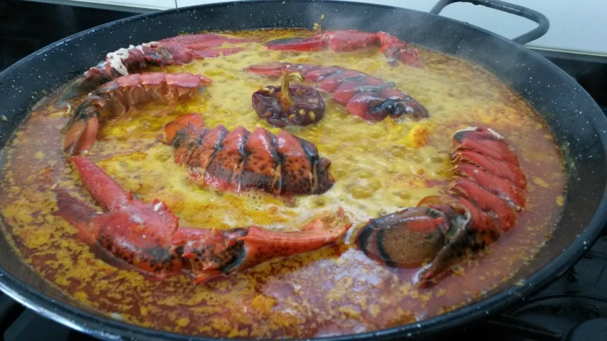 there is a pot with food that looks like a lobster
