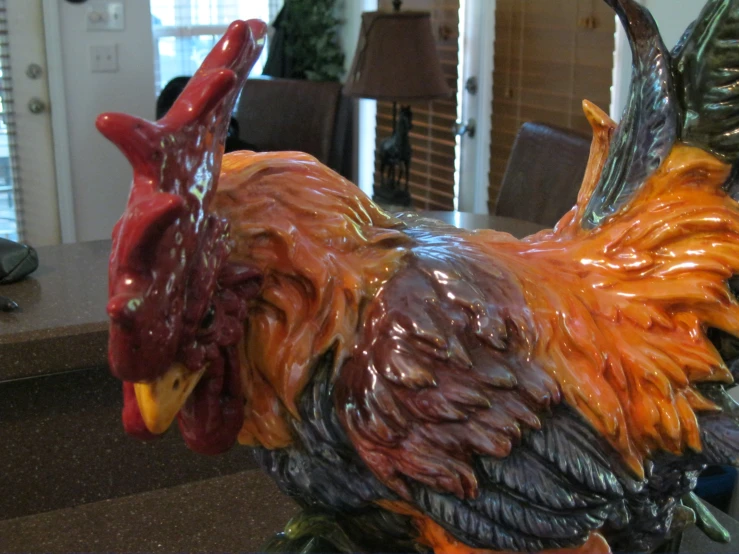 a statue of a rooster on a table