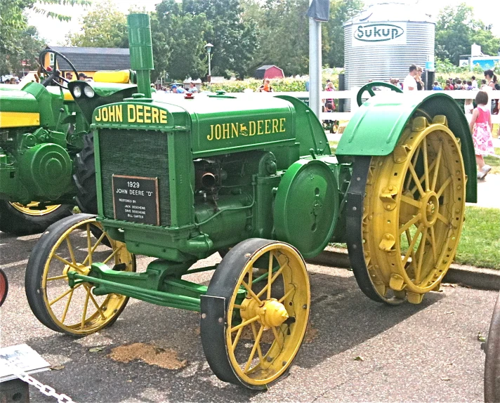 green and yellow two wheeled tractor on display