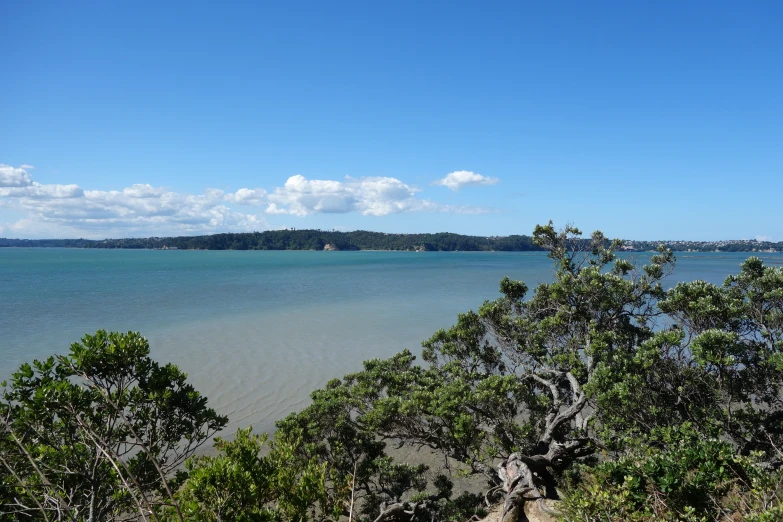 the blue and clear water looks very calm from the hill