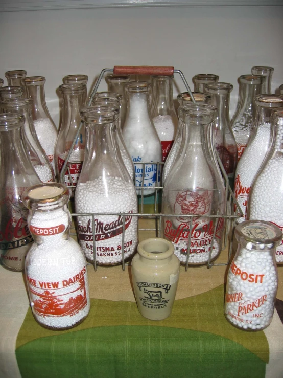 old antique glass milk bottles are displayed for sale