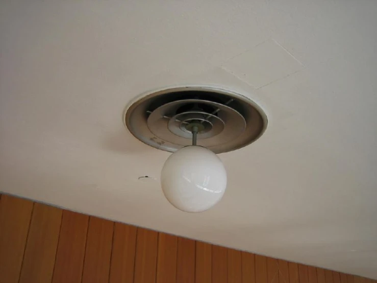 a white light bulb on the ceiling in a home