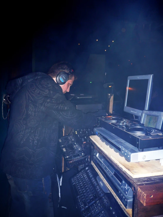 a man with headphones operating sound equipment