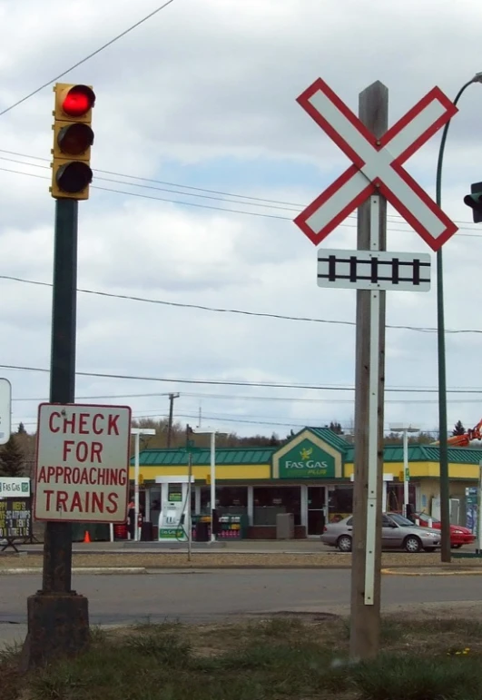 some signs for railroad crossing and railroad crossing lights