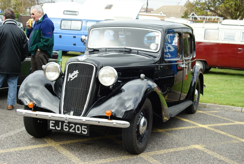 an old model ford car is parked in a lot