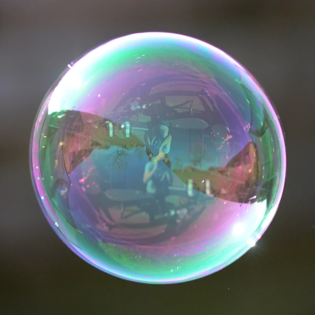 a bubble on a black background with blurry colors