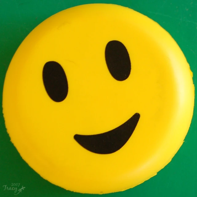 a yellow smiley face cake that is ready to be eaten