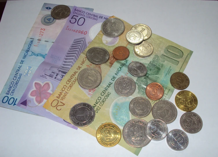 a pile of coins laying on top of a white counter