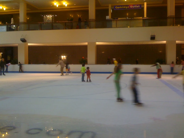 there are children on skateboards playing on the ice