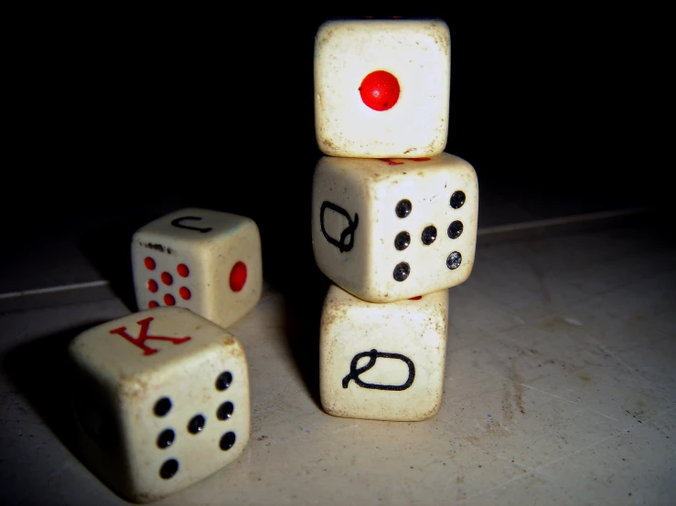 three dices on the ground with writing on them
