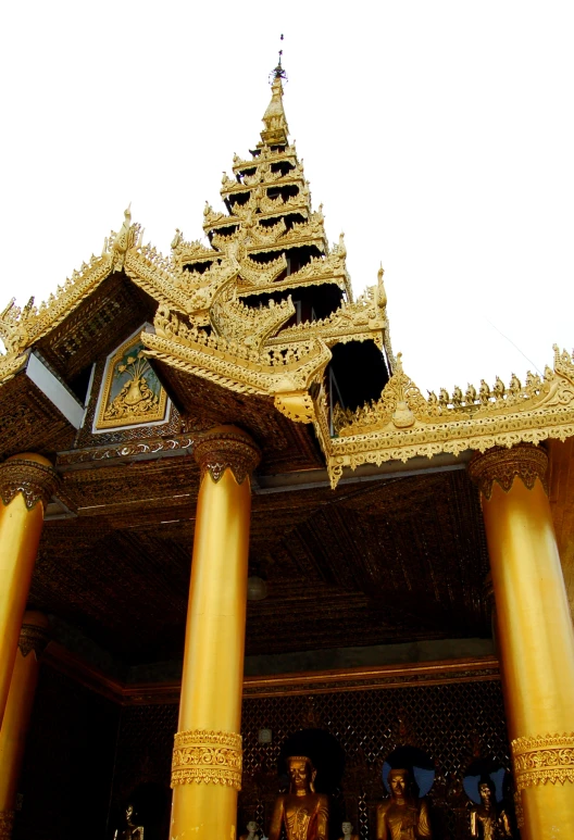 ornate gold pillars adorn the roof of a building