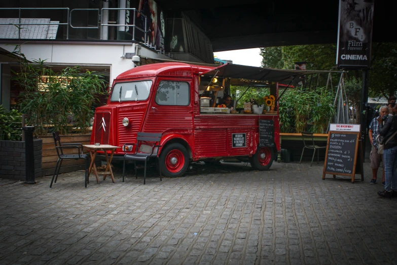 a red truck parked next to a patio in a room