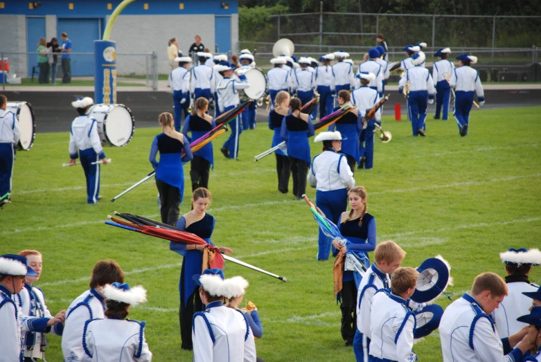 a marching team holding their batons during a parade