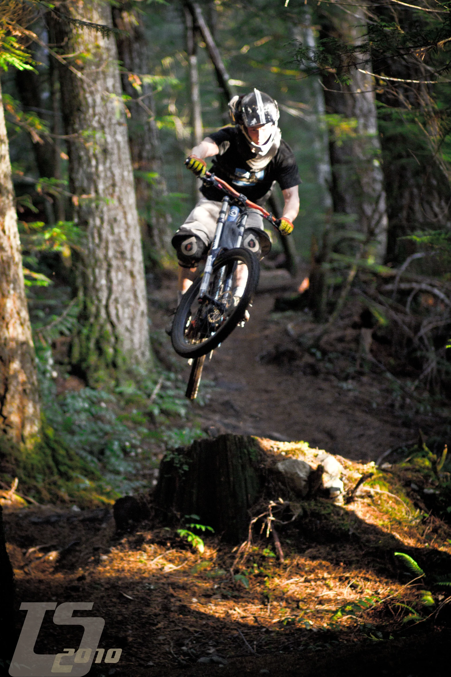 a person on a dirt bike doing stunts in the woods