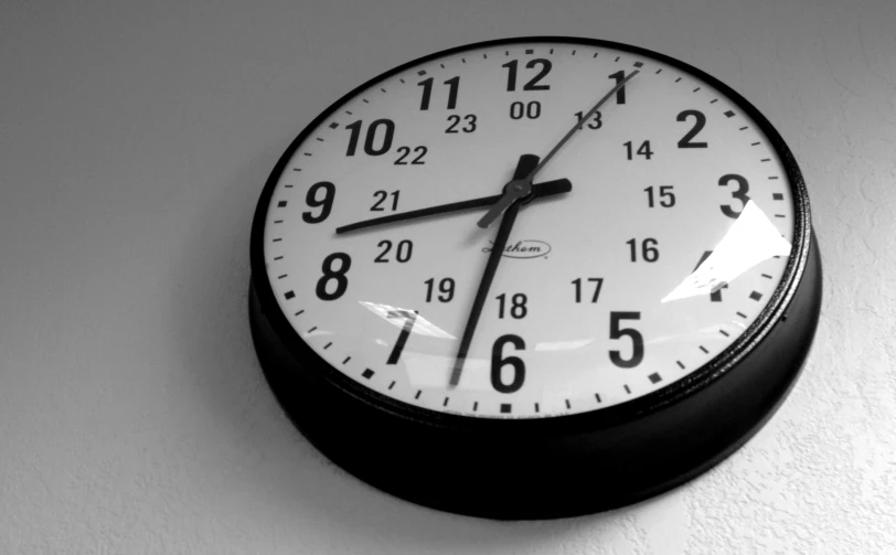 black and white clock with numbers indicating 5 to five