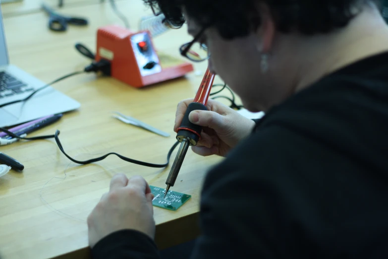 a man using a pen to build a circuit board