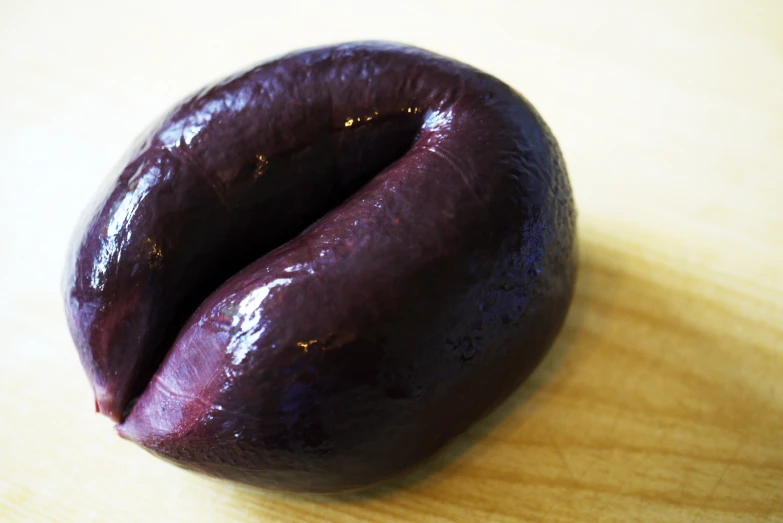 a purple fruit is on top of a table