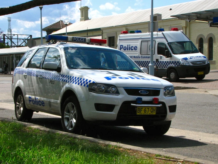 an emergency vehicle parked at a station in a town