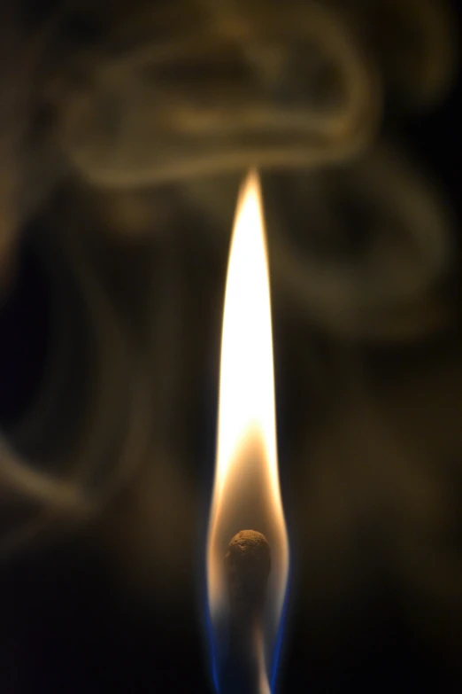 a candle with a light on the edge