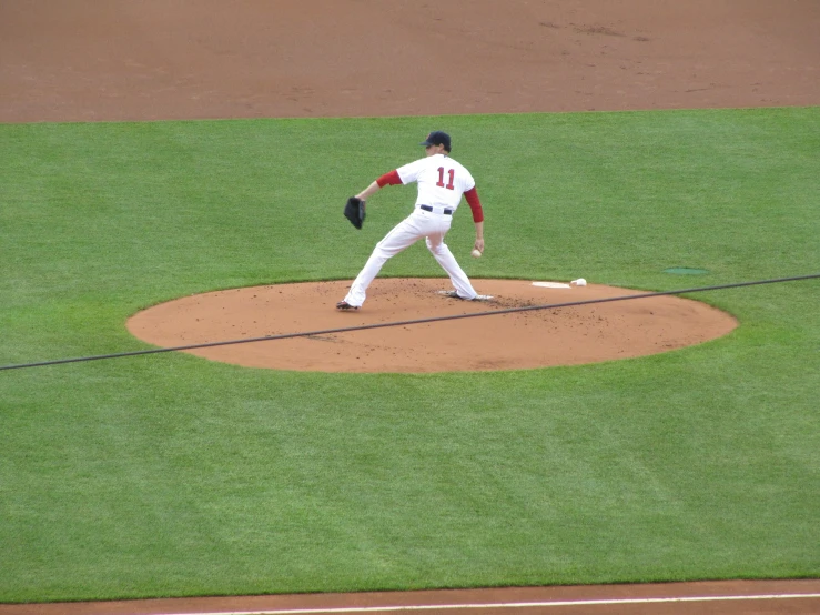 pitcher on mound with mitt raised ready to throw ball