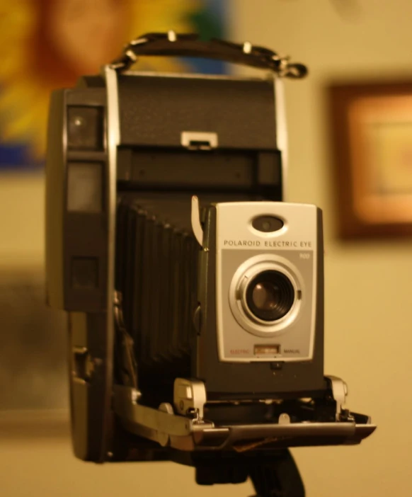 an antique camera on top of a tripod