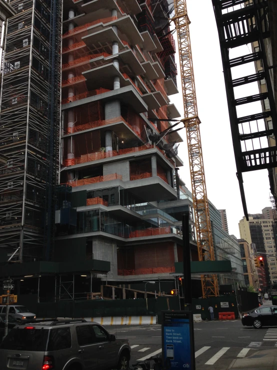 several construction cranes at the intersection of a city