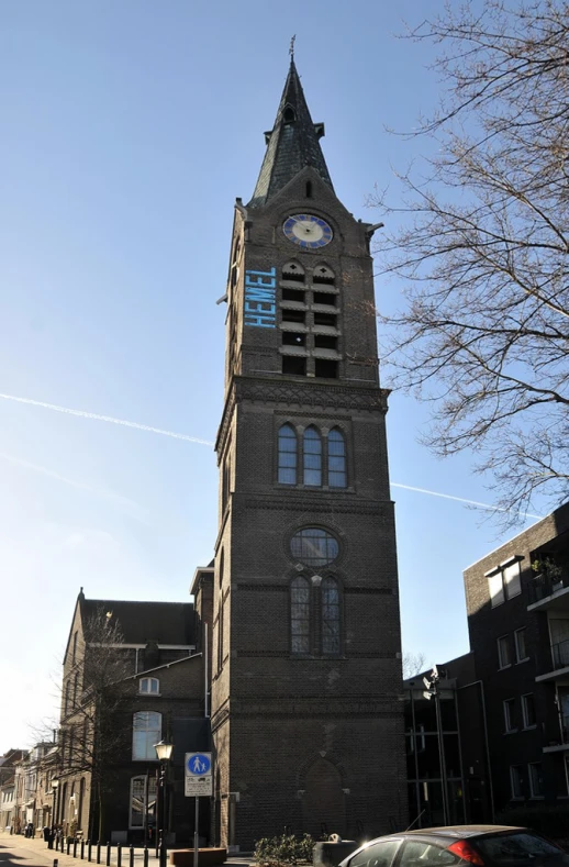 an old clock tower on the corner of a city street