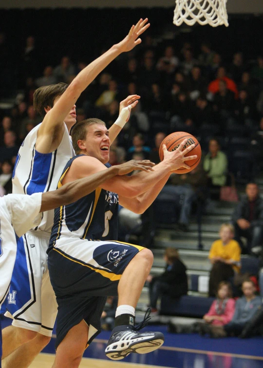 the basketball players are going after a basket