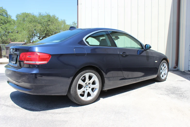 there is a blue bmw car that is parked