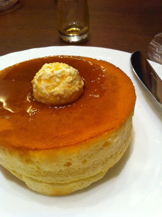 a stack of pancakes covered with caramel syrup