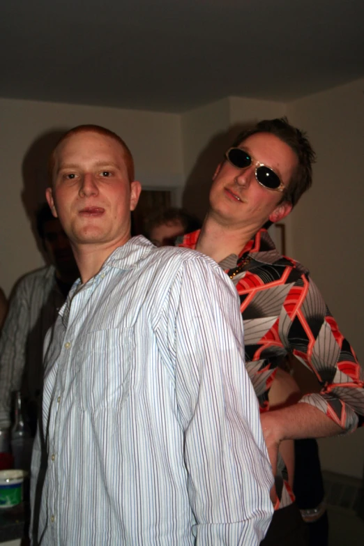 a couple of men wearing sunglasses and a shirt