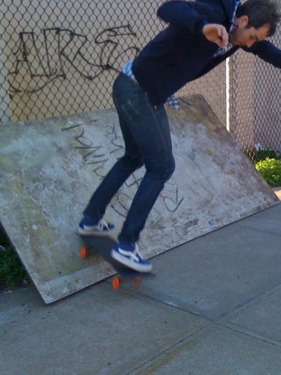 a young man is skateboarding down the concrete ramp