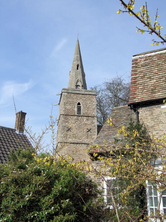 the tower of a church has steeples with an old - fashioned clock