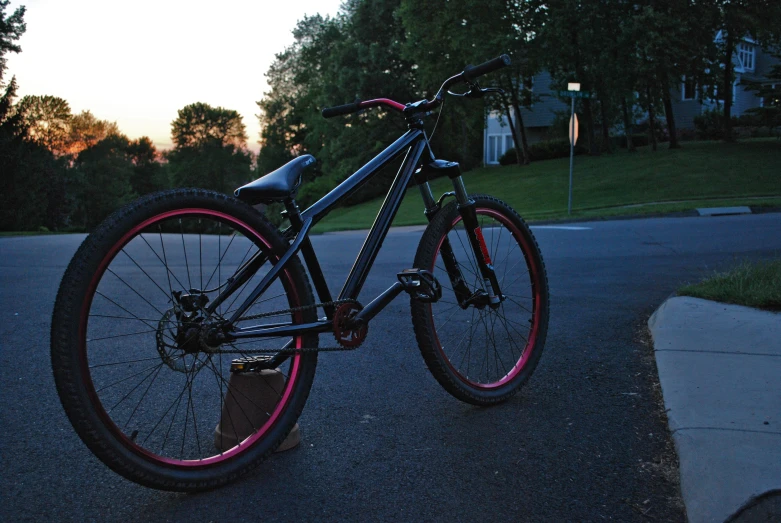 a bike parked by the road at dusk