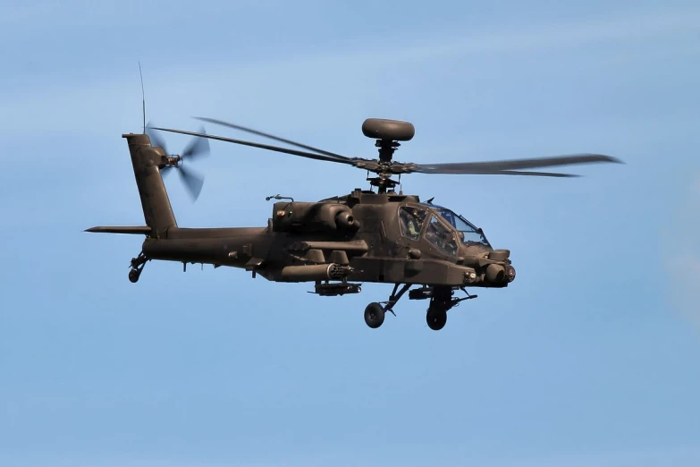 a helicopter flies through a cloudless sky