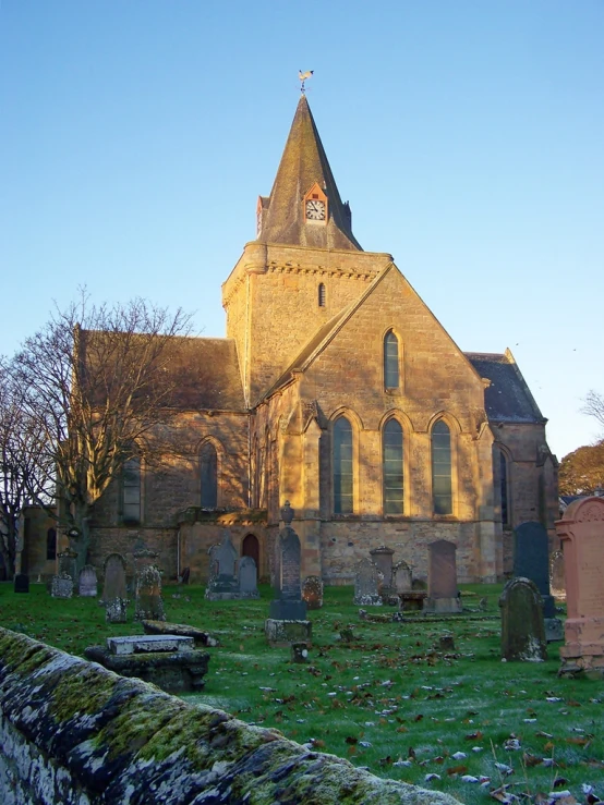 a very tall brick church with a cross tower