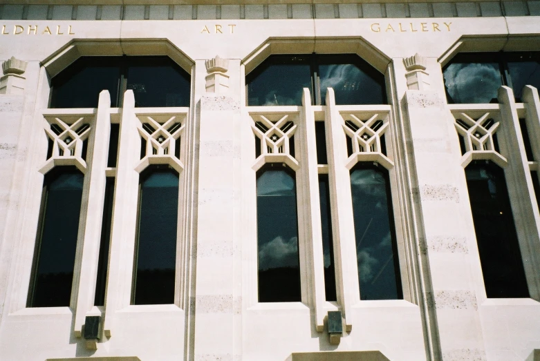 decorative windows on the facade of a tall building