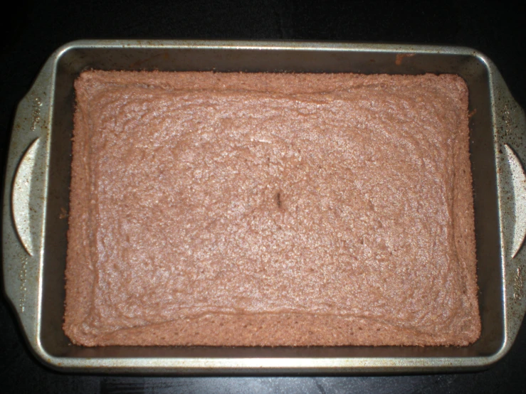 a pan filled with brownish and white frosting