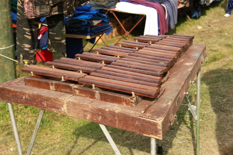 a wooden musical instrument on a table in the grass
