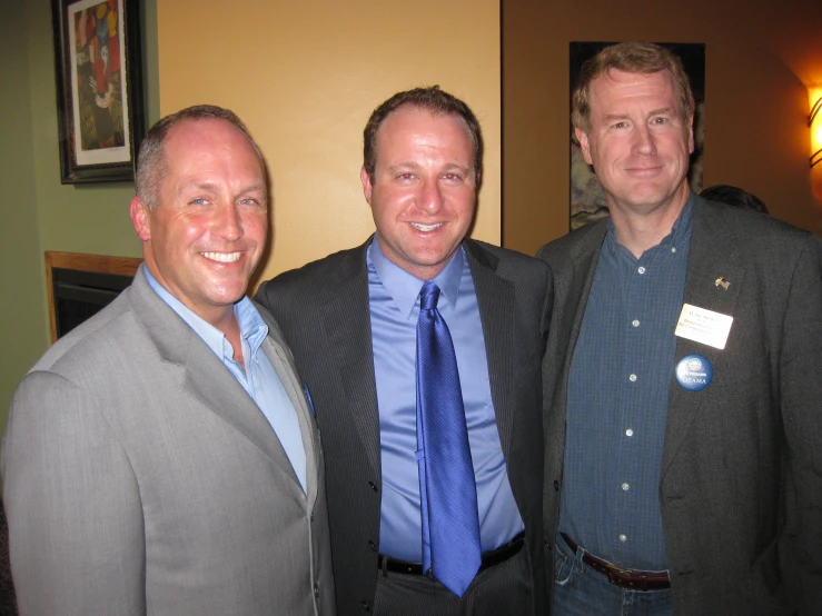 three men smiling and posing for the camera