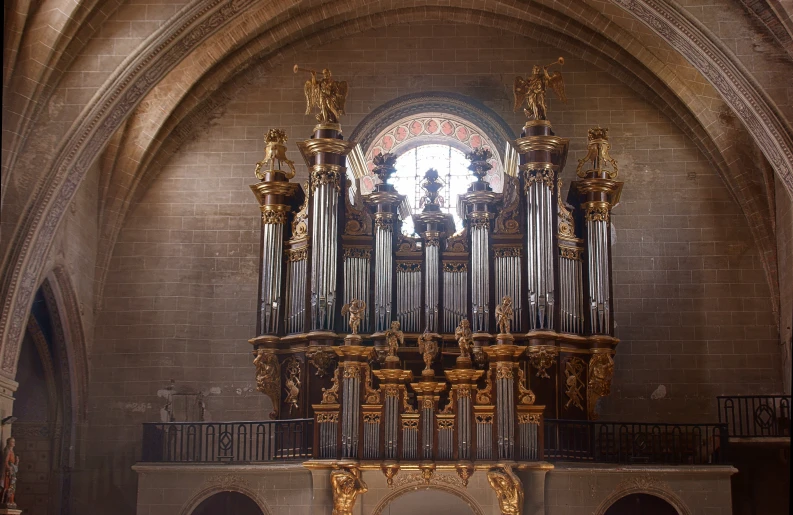 an ornate pipe organ and the stained glass window