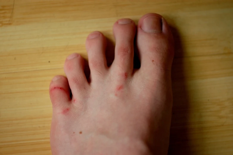 a close up of a person's foot and hands