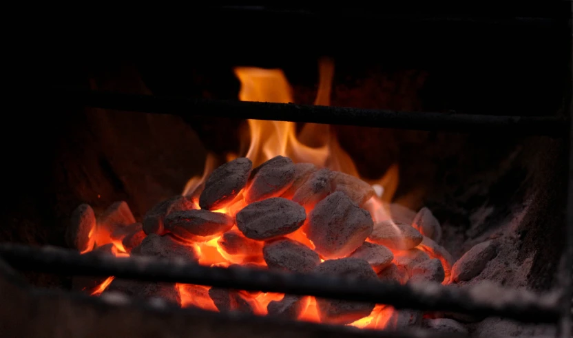 a stove burning with rocks inside of it