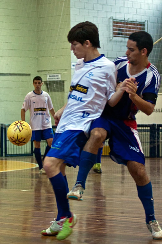 some young men on a court playing soccer