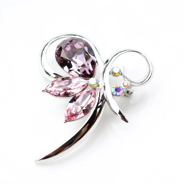 a purple flower brooch with swaroes