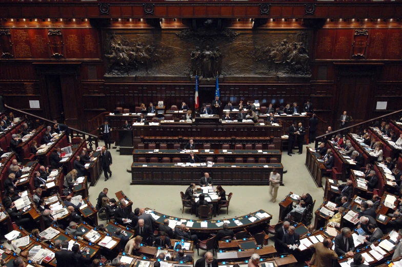 an aerial view of a large building with people in the court of the house